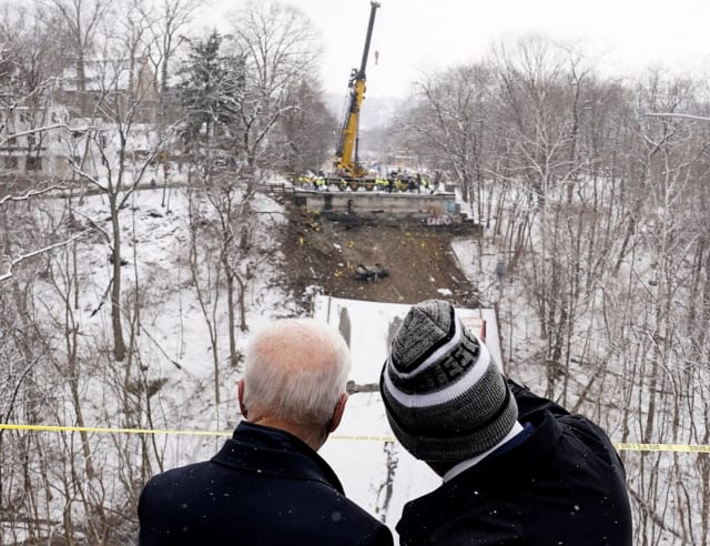 Caption: President Joe Biden surveys the wreckage with Pittsburgh Mayor Ed Gainey (Credit: Kevin Lamarque / Reuters)