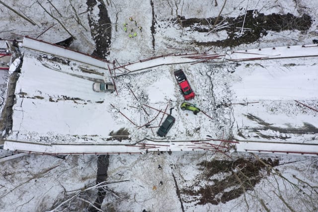 Caption: Damaged vehicles seen from above at the base of the collapse (Credit: Reuters)