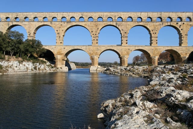 The Pont du Gard aqueduct is one of the most iconic Roman structures left standing in modern times. Stock photo.