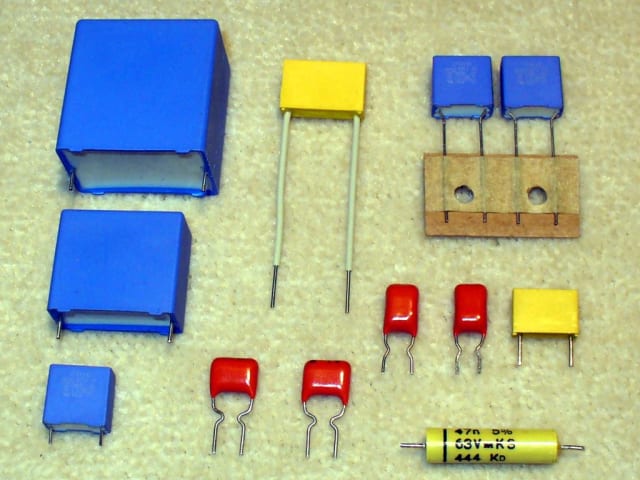 A variety of plastic film capacitors. (Image: Wikimedia/Elcap.)